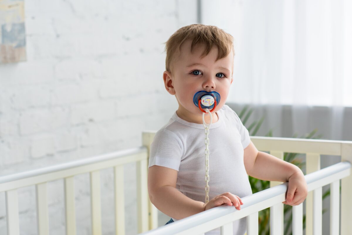 cute-little-baby-boy-with-pacifier-in-baby-crib-lo-2021-08-29-21-19-46-utc-1200x801.jpg